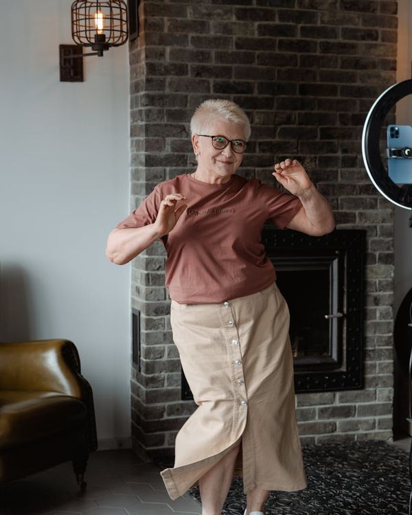 Woman feeling energetic and happy during a light workout at home.